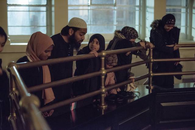 Male and Female members of Brick Lane Mosque congregation discuss the artwork during site-performance in main prayer hall